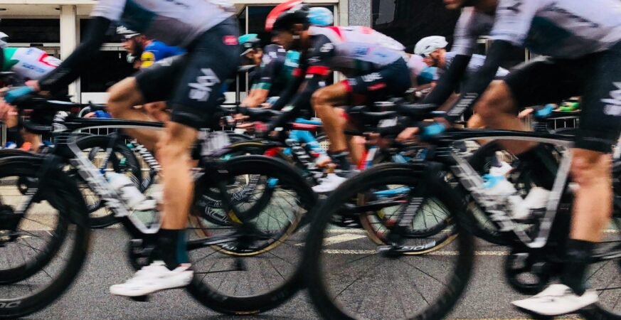 Men ride on black bikes scaled